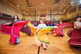 Rusty Rae/News-Register##Lesly Aguilar, left, Gaby Flores, and Rosario Barba, and other members of the Baile Folklorico at McMinnville High School twirl their colorful skirts during a rehearsal for a performance at the Dia de los Niños (Children’s Day) event, planned for 1 to 4 p.m. on Saturday, April 29, at the McMinnville Public Library.