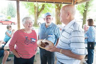 Marcus Larson/News-RegisterBonnie and Norman Clow chat with Jim McFarlane about their childhood days during a reunion for those who attended local country schools.
