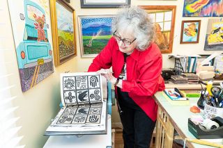 Marcus Larson/News-Register##Artist Phyllice Bradner demonstrates her printing press with a piece comprised of several sacred symbols. Her prints will be featured in an upcoming Currents Gallery show.