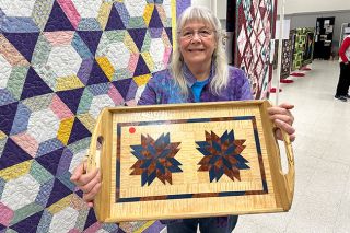 Kirby Neumann-Rea/News-Register##Coastal Hills Quilters founder Cris Darr of Willamina holds up a tray made by her late husband, George. The Rock Candy pattern is made using Kewazinga, curly maple and dyed poplar in a white oak frame. Kirby Neumann-Rea/News-Register
Coastal Hills Quilters founder Cris Darr of Willamina holds up a tray made by her late husband, George. The Rock Candy pattern is made using Kewazinga, curly maple and dyed poplar in a white oak frame.