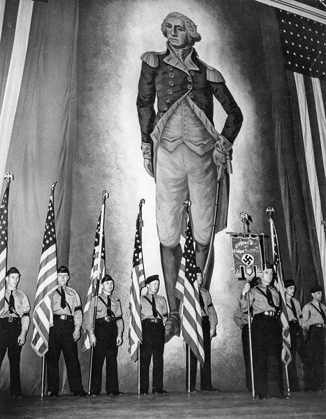 ##A color guard holds American flags and a banner emblazoned with a swastika during the German American Bund rally in February 1939 in New York City. The three-hour event, described on posters as a “Mass Demonstration for True Americanism,” drew 20,000 people to Madison Square Garden.