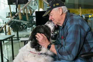 Rusty Rae/News-Register##Veteran Dave Cutter with his therapy dog, Lucy. “She’s all love,” he said.