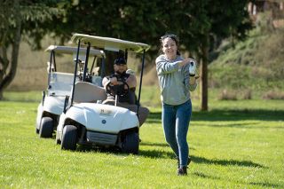 Rachel Thompson/News-Register##Shelbylinn Connell of Monmouth hits from the fairway on The Nines, formerly Bayou, south of McMinnville. With her is Lee Waggoner, also from Monmouth.