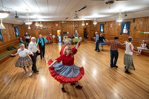 Rusty Rae/News-Register##Round dance couples — including Deena and Don Myatt, center, Jennie and Nate Ramer, front left, and Kevin Steward and Carol Roos, front right — circle the floor at the McMinnville Grange Hall, where the Braids and Braves Square Dance Club hosts events on the third Saturday of each month. Round dances alternate with square dances, which involve four couples moving in a square formation.