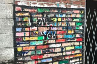 Kirby Neumann-Rea/News-Register##Before it was Art Alley, someone started painting old bricks with bright colors. Kirby Neumann-Rea/News-Register##Before it was Art Alley, someone started painting old bricks with bright colors.